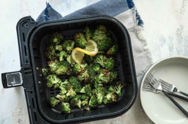 Air fryer broccoli in an air fryer basket.