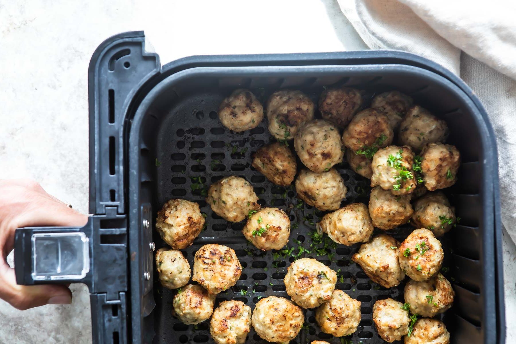 Meatballs in an air fryer.