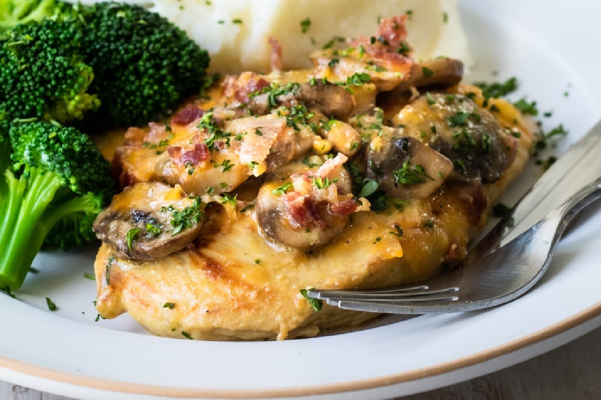 Alice Springs chicken on a plate with broccoli.