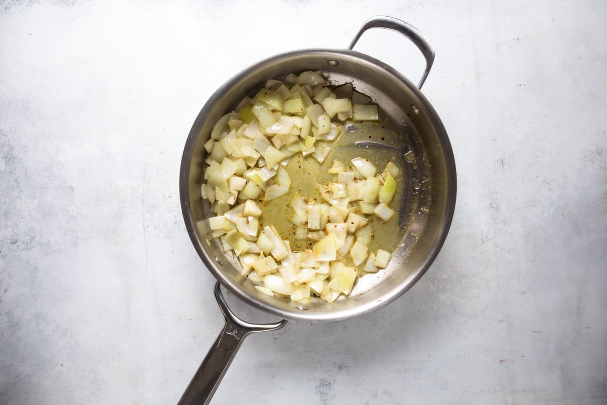 Cooking artichoke hearts in a skillet.