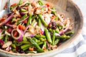 Asparagus salad in a wooden bowl.