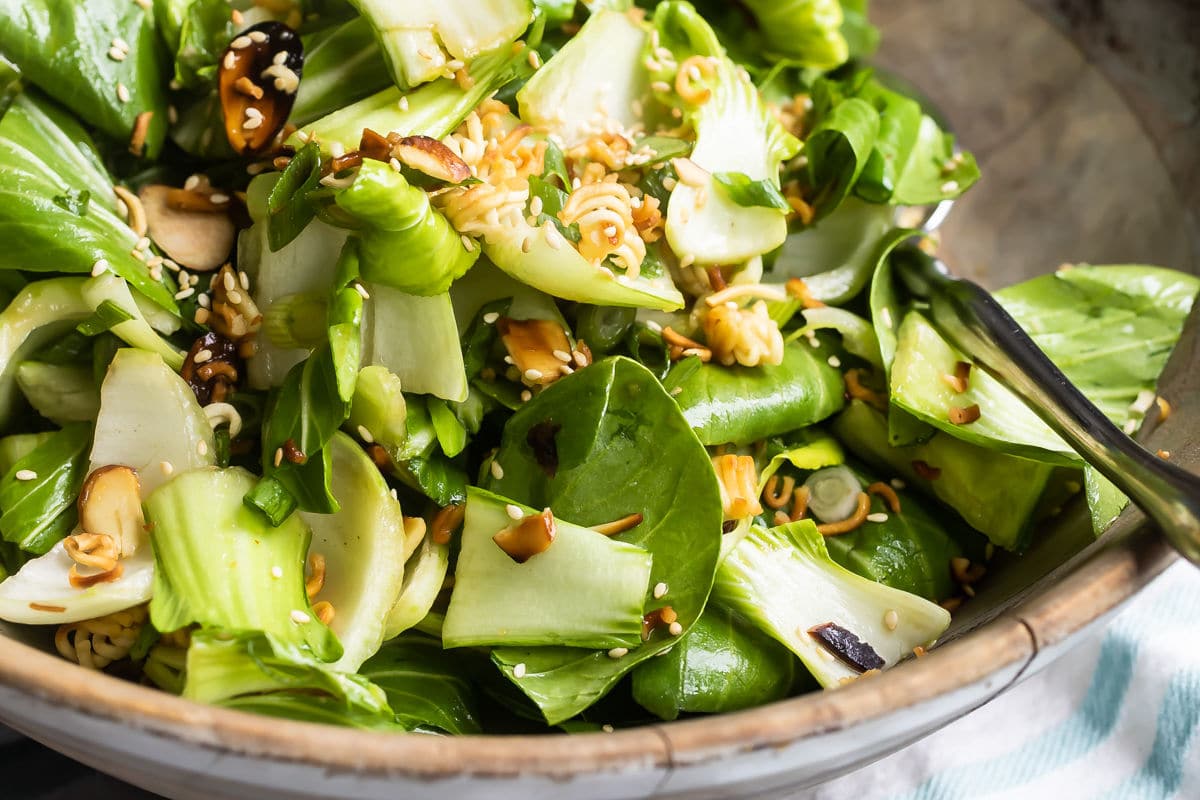 Baby bok choy salad in a wooden bowl.