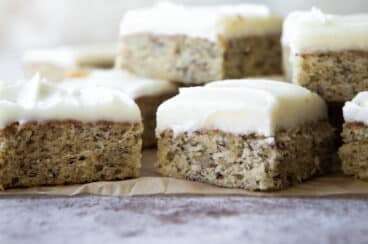 A pile of banana bars on a piece of parchment paper.