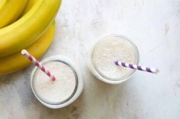 2 jars with Banana Smoothies and straws.