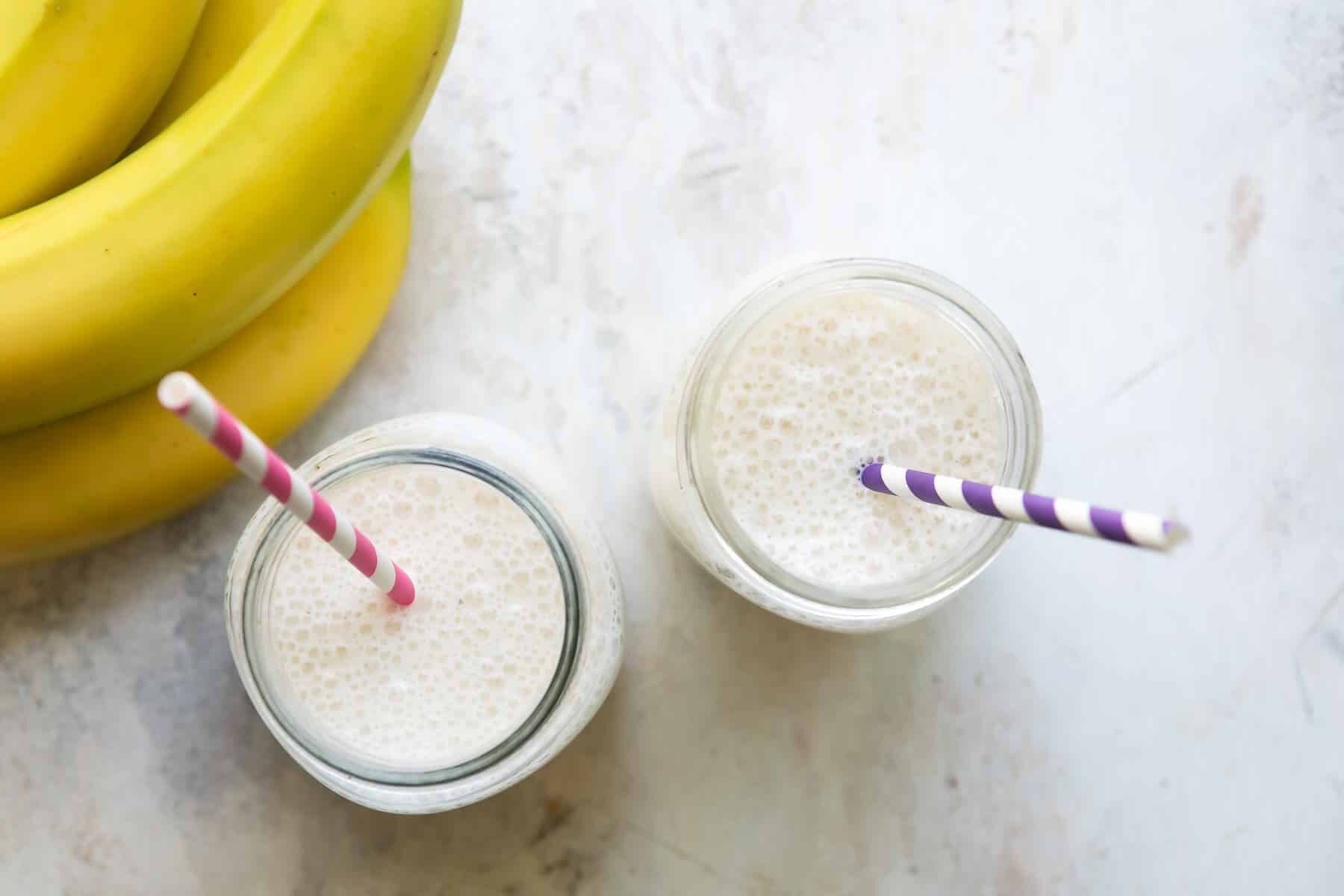 2 jars with Banana Smoothies and straws.
