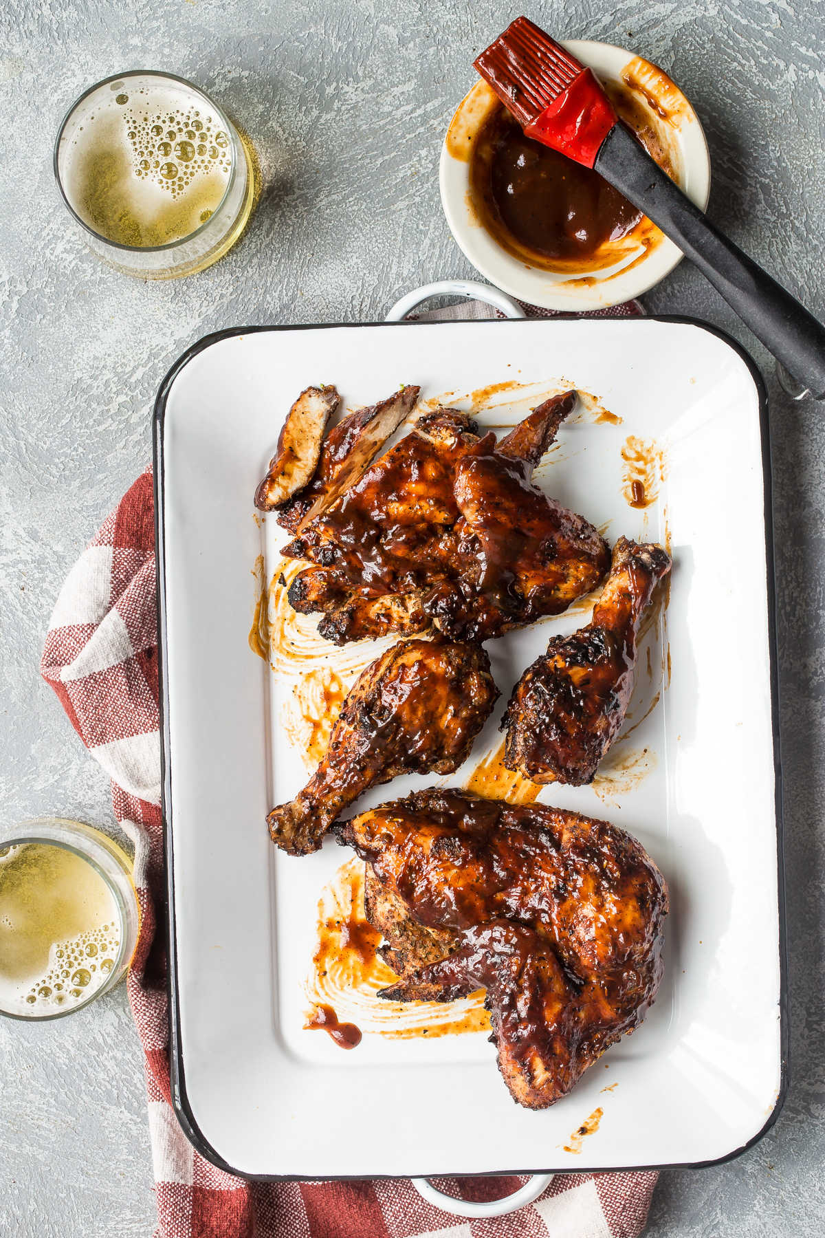 Barbecue chicken on a white platter.
