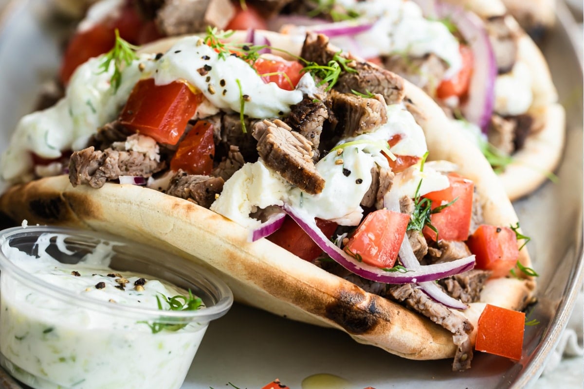 A beef gyro on a platter.
