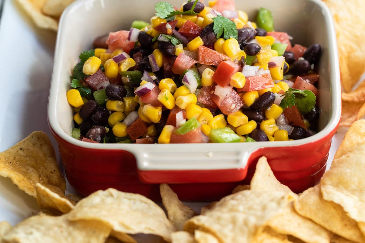 Black bean salsa in a red square dish.