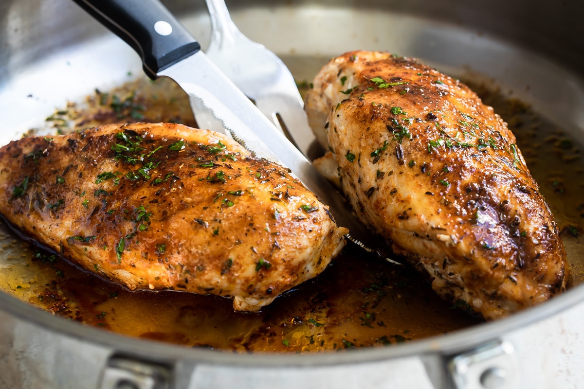 Blacked chicken in a skillet.