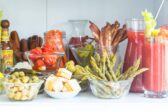 A bloody mary bar set up on a countertop.