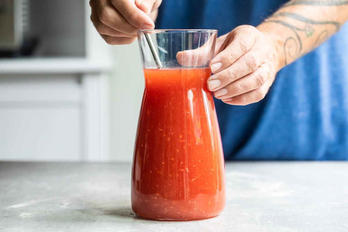A pitcher of bloody mary mix.