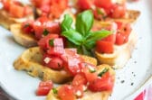 Bruschetta on a white platter.