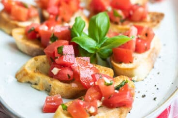 Bruschetta on a white platter.