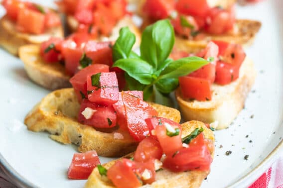 Bruschetta on a white platter.