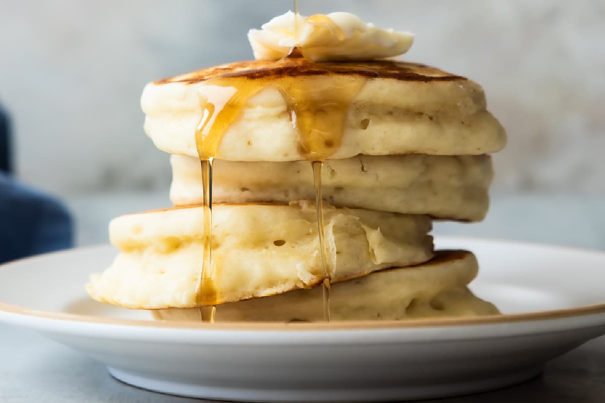 A stack of buttermilk pancakes on a plate.