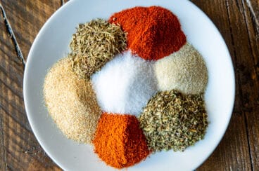 Cajun seasoning spices on a white plate.