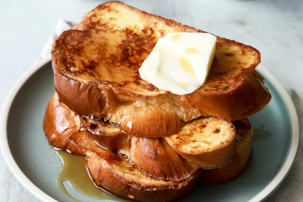A plate of 3 slices of Challah French toast.