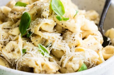 A bowl of cheese tortellini in garlic butter.