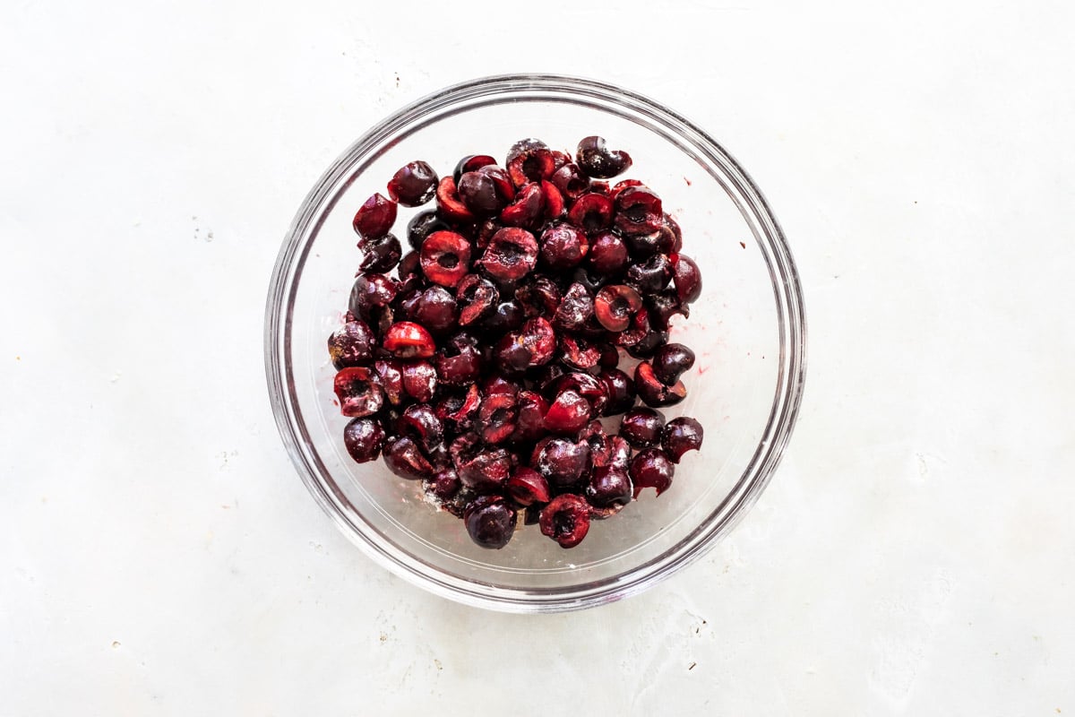 A bowl of chopped fresh cherries.