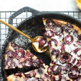 A cast iron skillet with Cherry Clafoutis.