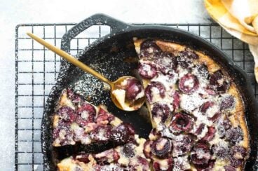 A cast iron skillet with Cherry Clafoutis.