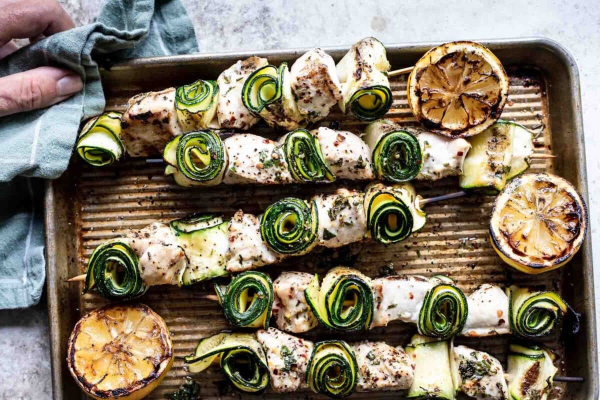 Chicken kabobs on a baking sheet.