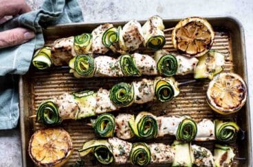 Chicken kabobs on a baking sheet.