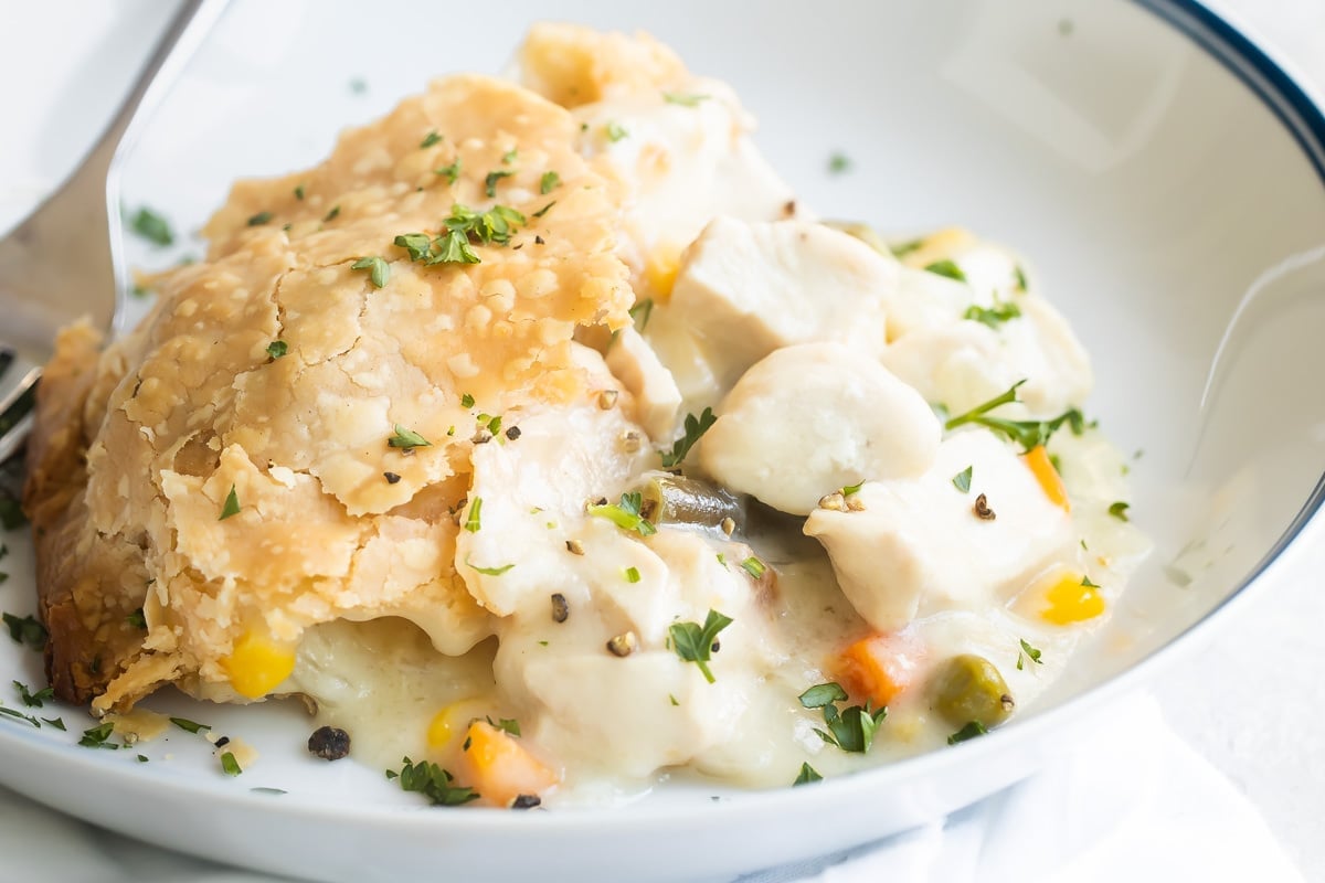 Chicken pot pie in a white dish.