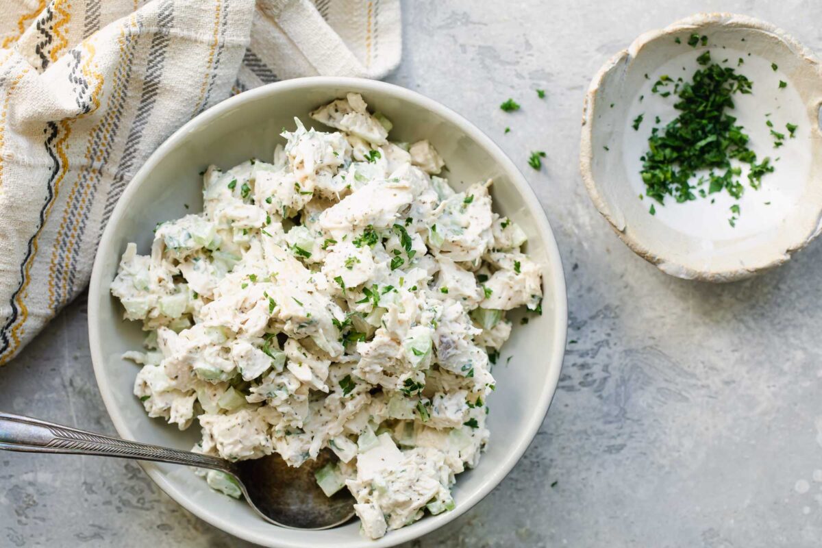 A white bowl with chicken salad.