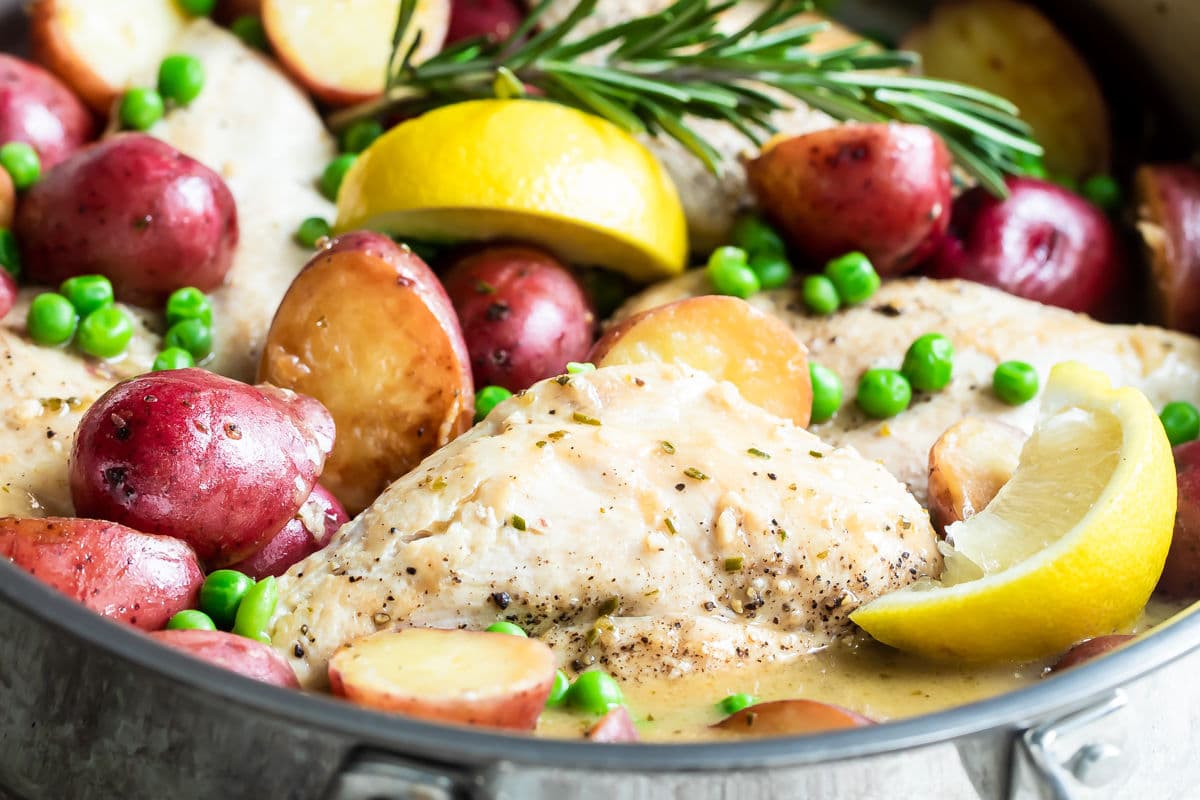 Chicken vesuvio in a silver skillet.