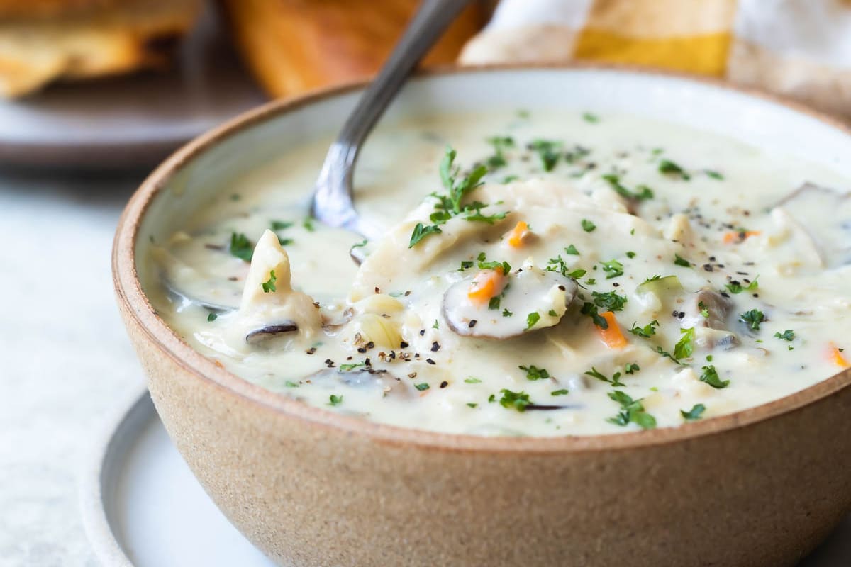Chicken wild rice soup in a brown bowl.
