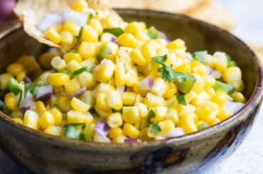 Chipotle corn salsa in a black bowl.