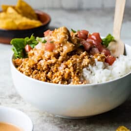 A white bowl with rice and Chipotle Sofritas.
