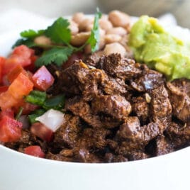 A bowl of Chipotle steak, pinto beans, cilantro-lime rice, and pico de gallo.