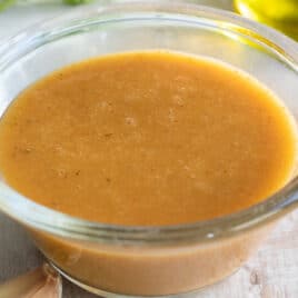 Chipotle vinaigrette in a clear bowl on a countertop.