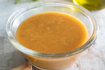 Chipotle vinaigrette in a clear bowl on a countertop.