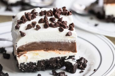 Chocolate lasagna slice on a white plate.
