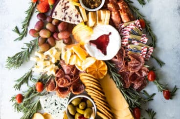 A christmas charcuterie board shaped like a christmas tree.