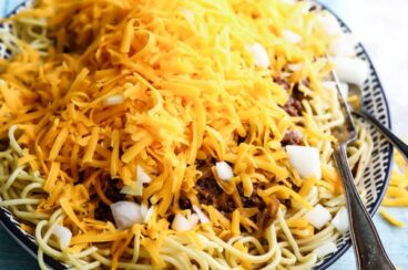 Cincinnati chili in a black and white serving dish.