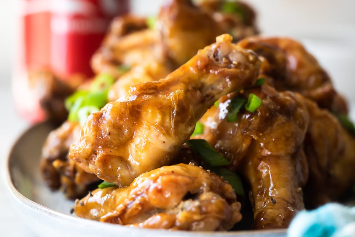 Coca Cola chicken wings on a white platter.