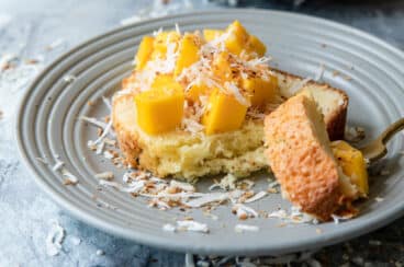 Coconut cake with mango cubes on top.