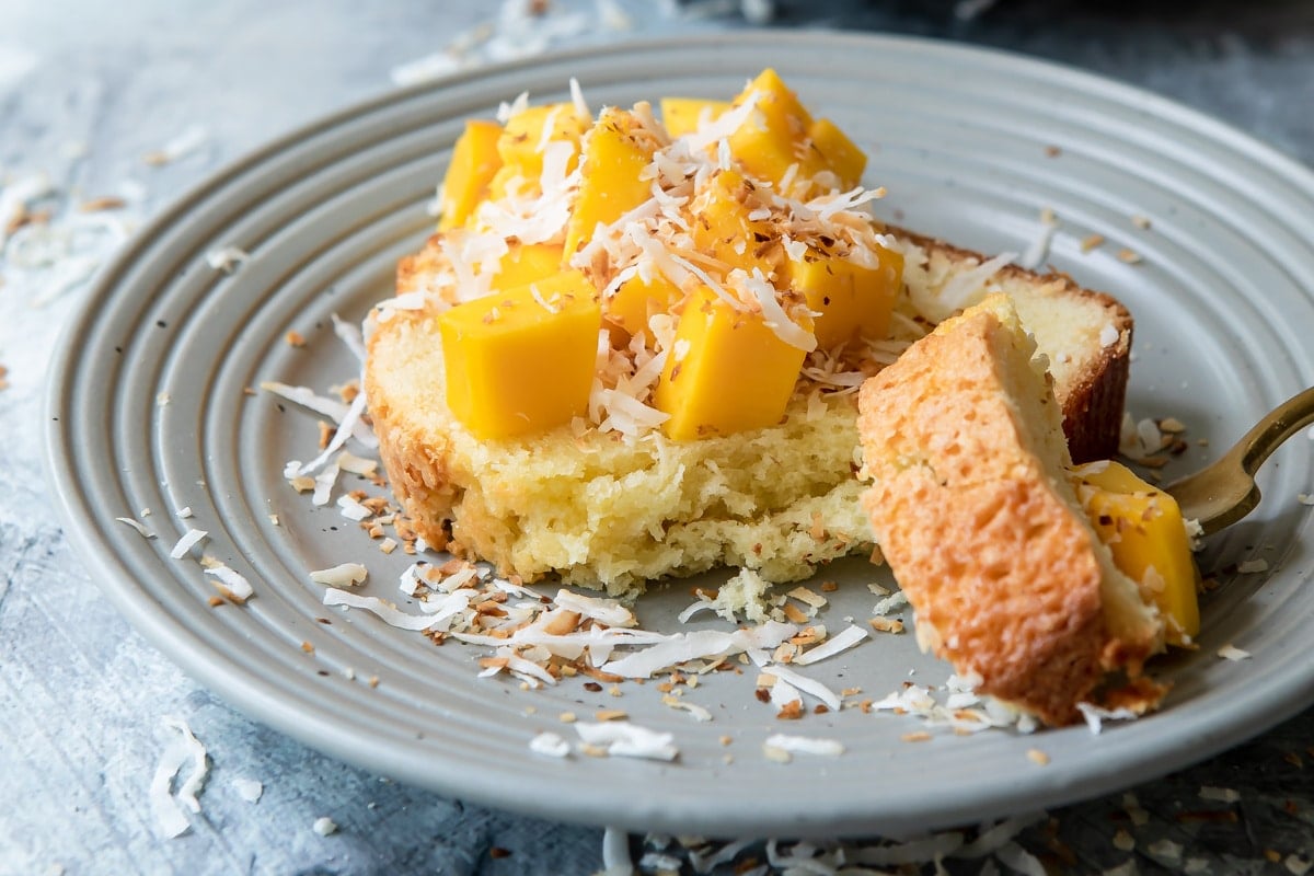 Coconut cake with mango cubes on top.