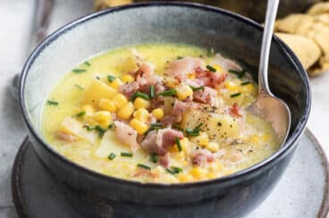 Corn chowder in a dark gray bowl.