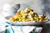 Corn salad on a white handmade platter.