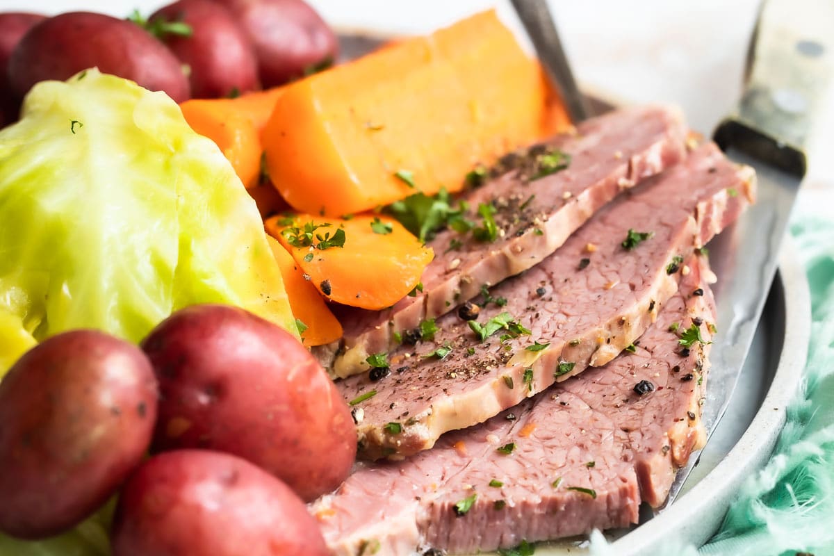 Corned beef, cabbage and potatoes on a round platter.