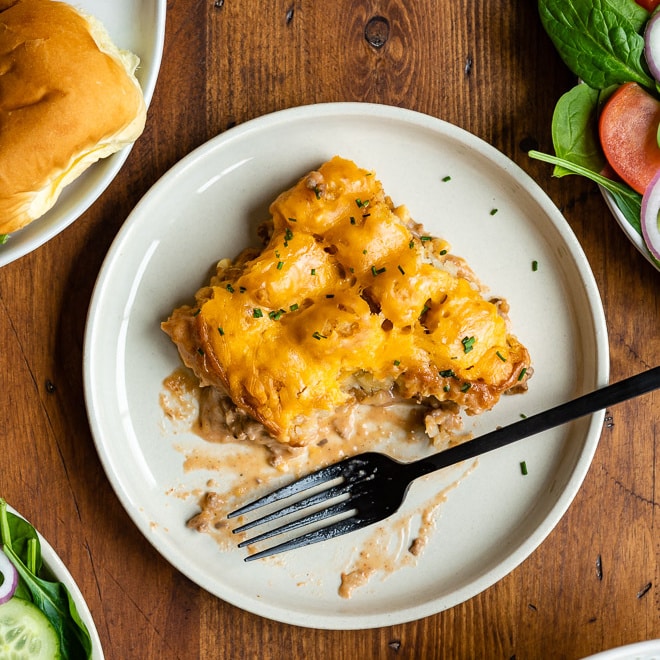 Cowboy casserole on a white plate with a silver fork.