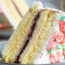 A slice of Danish Layer cake on a small gray plate.