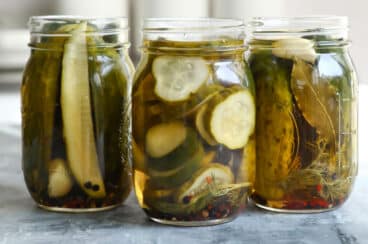 Three jars of pickles without lids.