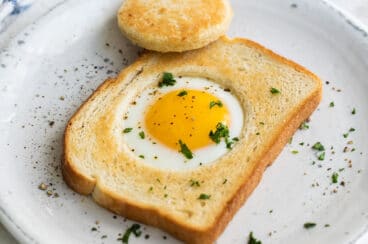 An egg cooked into a piece of bread.