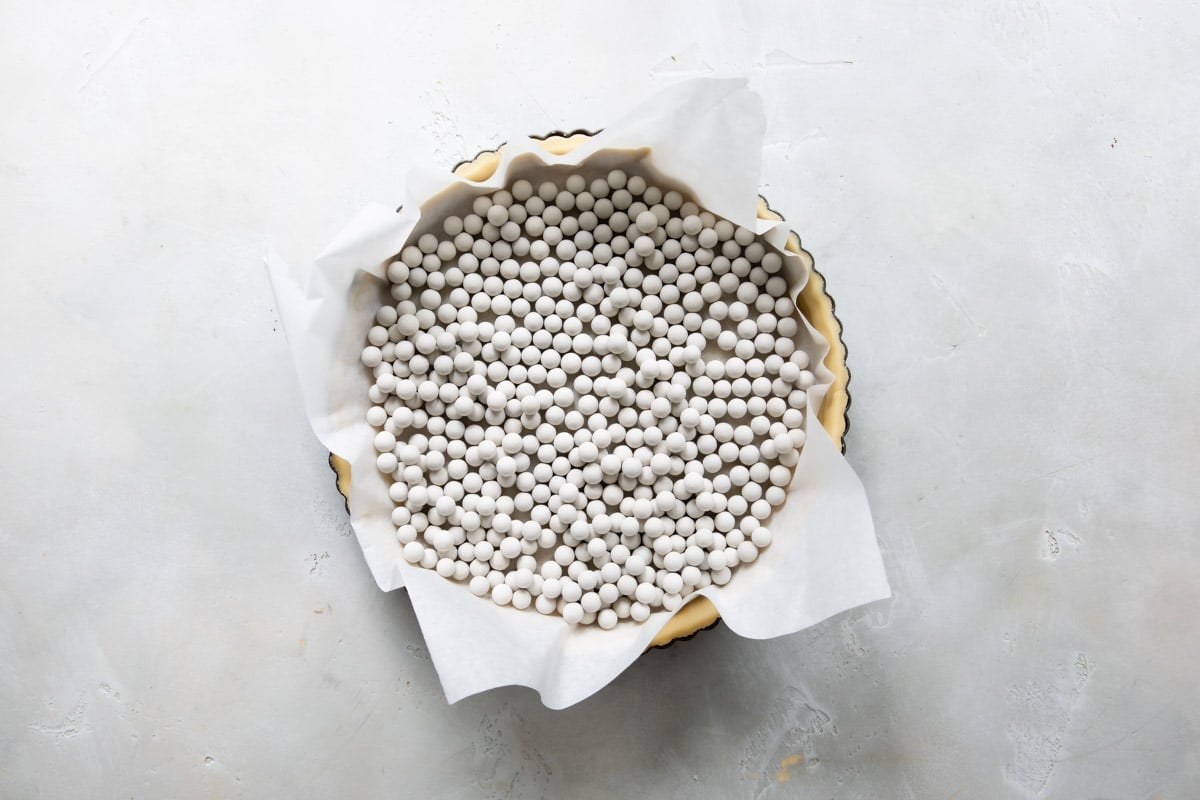 A tart crust with pie weights in it.